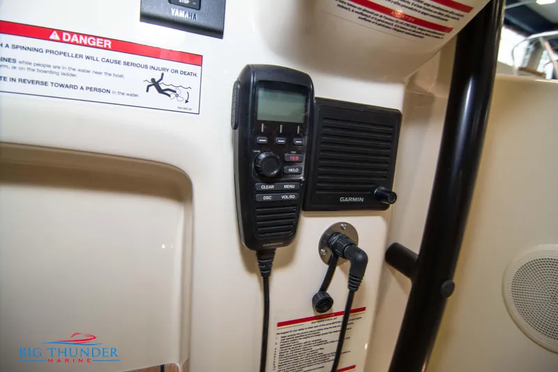 Slide: The Image of VHF radio and Garmin speaker on 2024 Capoforte CX240 boat dashboard. - 29