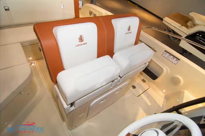 Slide: The Image of 2024 Capoforte CX240 boat interior with white and brown seating. - 34