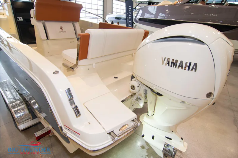 Slide: The Image of 2024 Capoforte CX240 boat with Yamaha outboard motor, featuring white and tan seating. - 7