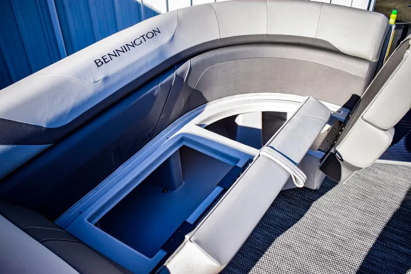 Slide: The Image of 2023 Bennington 22 SXCWSP boat interior with open storage compartment. - 14