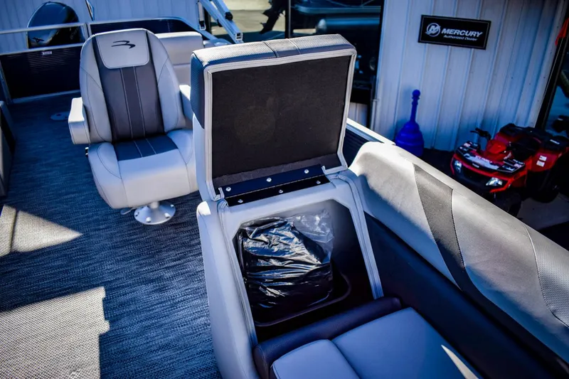 Slide: The Image of 2023 Bennington 22 SXCWSP boat interior with open storage compartment. - 16