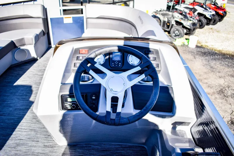 Slide: The Image of 2023 Bennington 22 SXCWSP boat dashboard with steering wheel and control panel. - 19