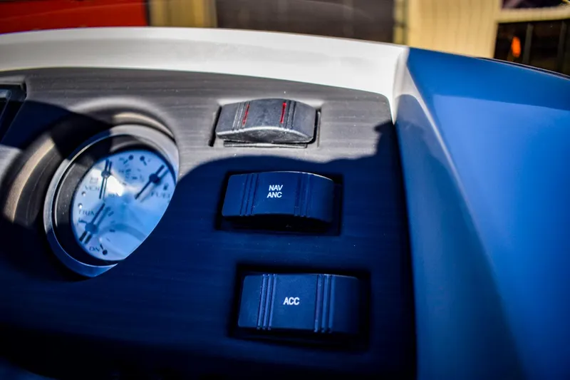 Slide: The Image of Close-up of 2023 Bennington 22 SXCWSP boat dashboard with switches and gauge. - 21