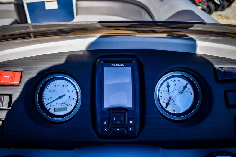 Slide: The Image of 2023 Bennington 22 SXCWSP dashboard with Garmin display and gauges. - 22