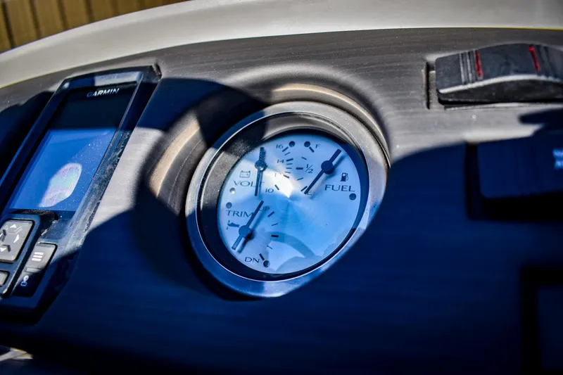 Slide: The Image of Close-up of 2023 Bennington 22 SXCWSP boat dashboard with gauges and controls. - 23