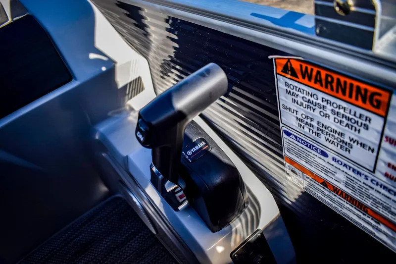 Slide: The Image of 2023 Bennington 22 SXCWSP boat throttle control and safety warning label. - 25