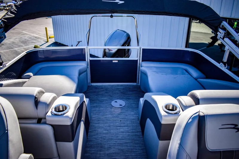Slide: The Image of 2023 Bennington 22 SXCWSP pontoon boat interior with seating and cup holders. - 27