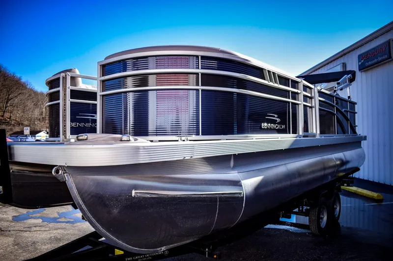 Slide: The Image of 2023 Bennington 22 SXCWSP pontoon boat on a trailer, side view. - 3
