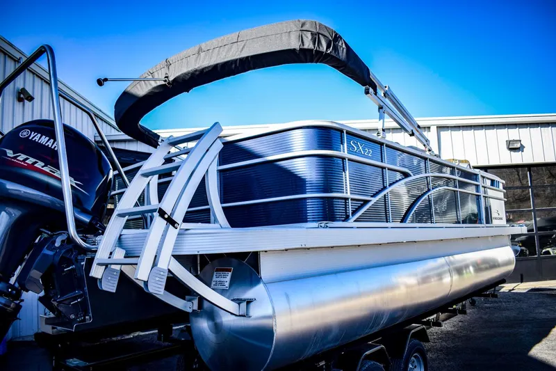 Slide: The Image of 2023 Bennington 22 SXCWSP pontoon boat with Yamaha motor in a marina. - 5