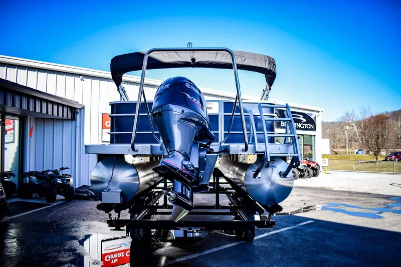 Slide: The Image of 2023 Bennington 22 SXCWSP pontoon boat with outboard motor in dealership lot. - 7