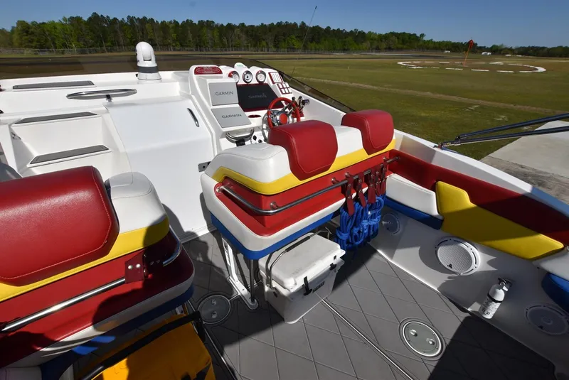 Slide: The Image of 2002 Black Thunder 460 EC boat interior with red, yellow, and white seating. - 10