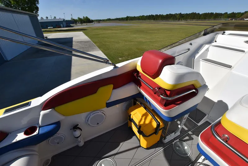 Slide: The Image of 2002 Black Thunder 460 EC boat interior with colorful seating and storage. - 11