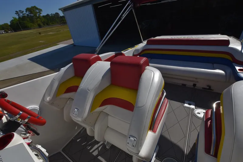 Slide: The Image of 2002 Black Thunder 460 EC boat interior with red, yellow, and white seating. - 13