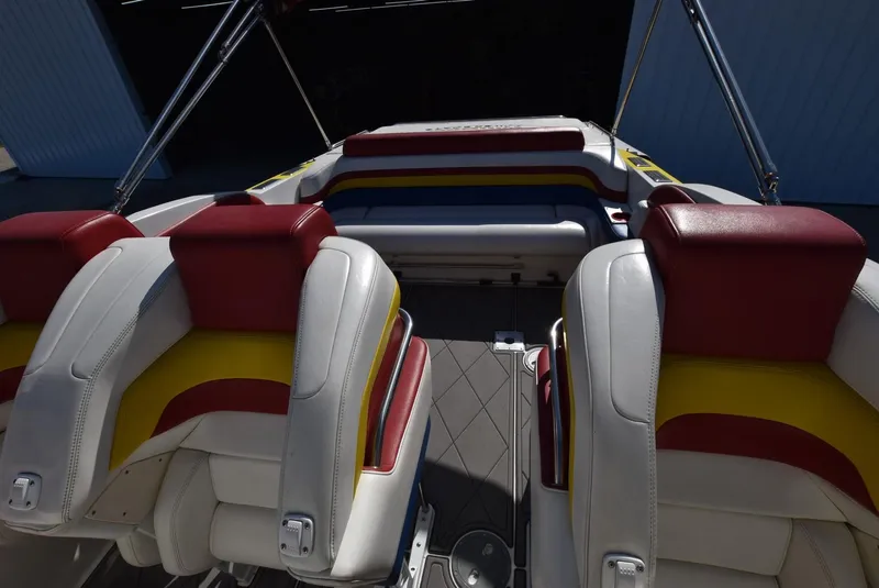 Slide: The Image of 2002 Black Thunder 460 EC boat interior with red, yellow, and white seating. - 14
