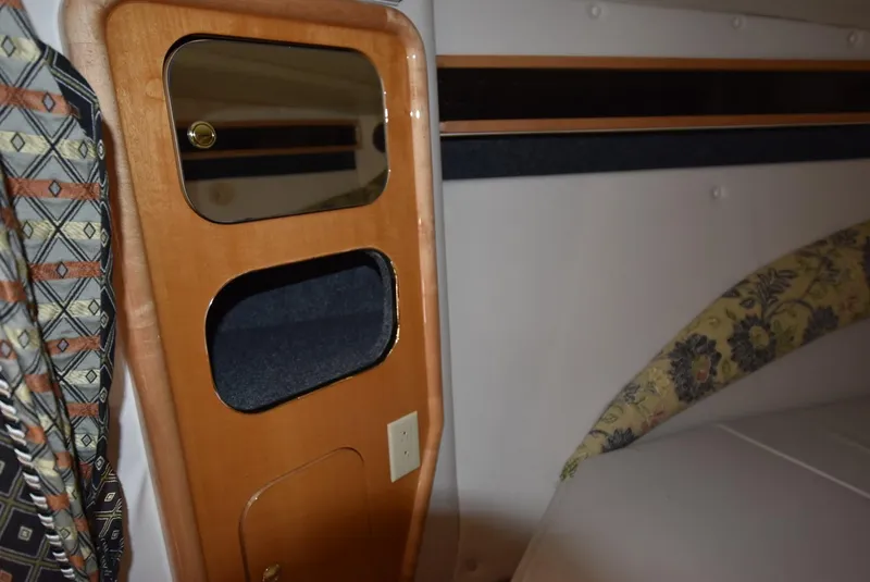 Slide: The Image of Interior cabin of a 2002 Black Thunder 460 EC boat with wooden storage compartments. - 21