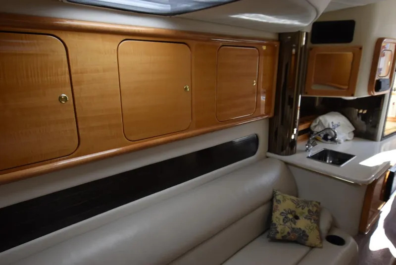 Slide: The Image of Interior of 2002 Black Thunder 460 EC boat with wooden cabinets and leather seating. - 23