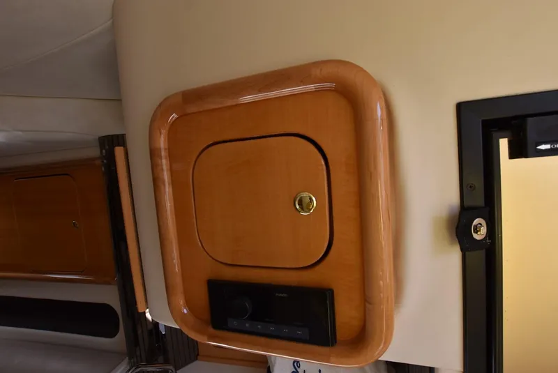 Slide: The Image of Wooden cabinet and control panel inside a 2002 Black Thunder 460 EC boat. - 25