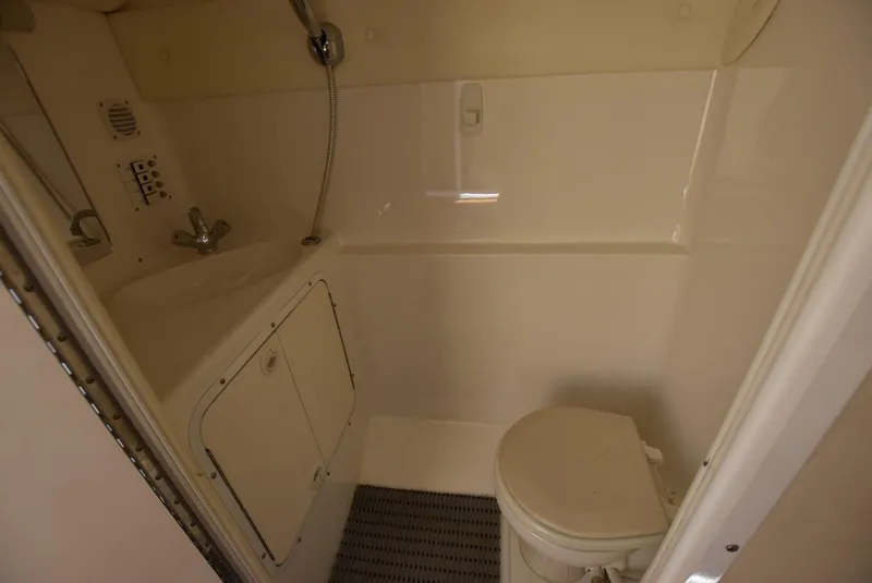 Slide: The Image of Compact bathroom in a 2002 Black Thunder 460 EC boat with sink, shower, and toilet. - 27