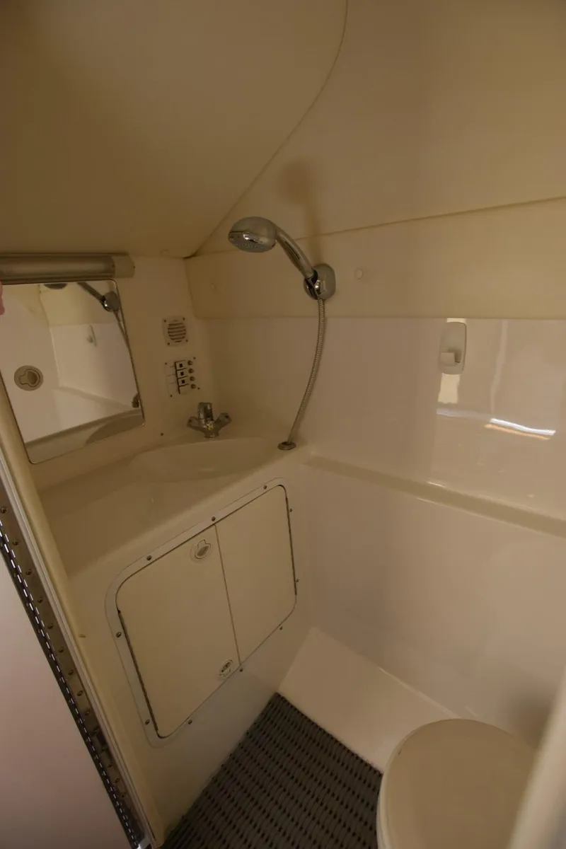 Slide: The Image of Compact bathroom in a 2002 Black Thunder 460 EC boat with shower and sink. - 28