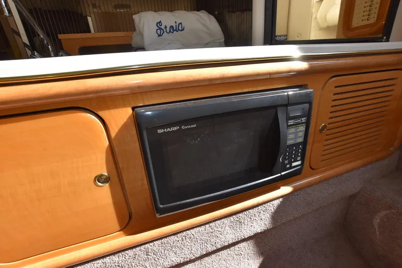 Slide: The Image of Built-in microwave in 2002 Black Thunder 460 EC boat's wooden interior. - 29