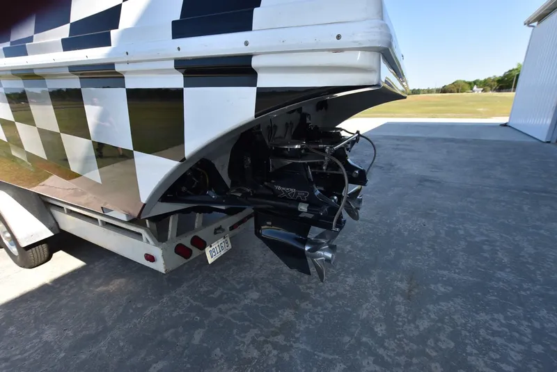 Slide: The Image of 2002 Black Thunder 460 EC boat on trailer, rear view with checkered pattern. - 3