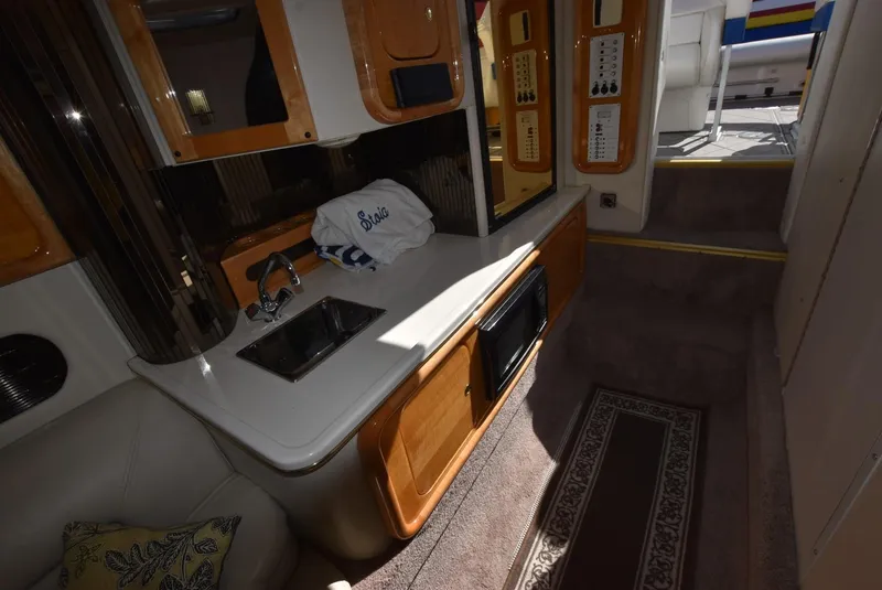 Slide: The Image of 2002 Black Thunder 460 EC boat interior with kitchenette and carpeted flooring. - 30