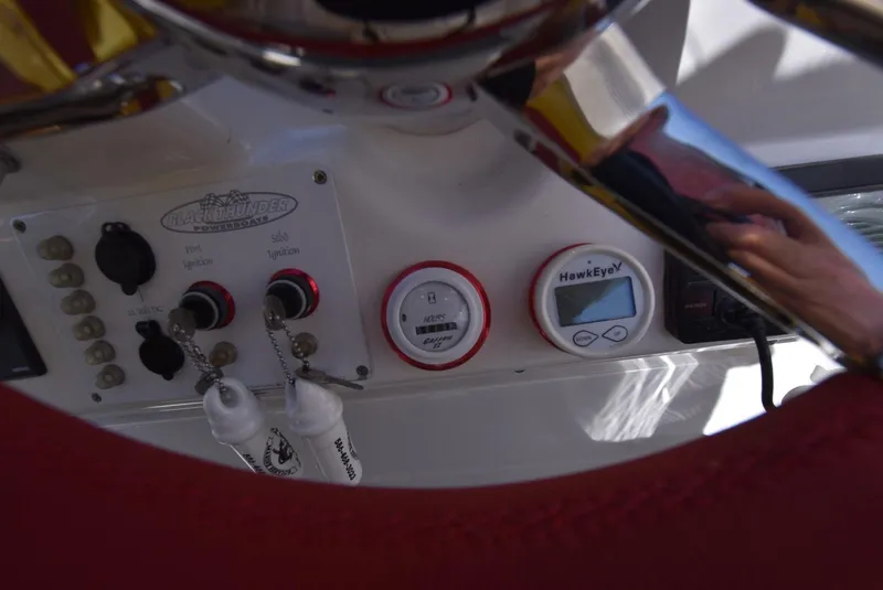 Slide: The Image of Control panel of a 2002 Black Thunder 460 EC boat with ignition switches and HawkEye gauge. - 31