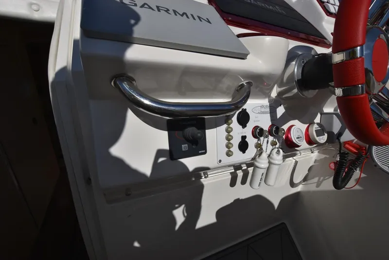 Slide: The Image of Control panel of a 2002 Black Thunder 460 EC boat with Garmin equipment. - 33