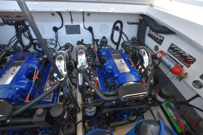 Slide: The Image of Engine compartment of a 2002 Black Thunder 460 EC boat with twin blue engines. - 36