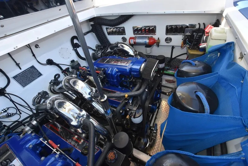 Slide: The Image of Engine compartment of a 2002 Black Thunder 460 EC boat with blue and chrome components. - 39