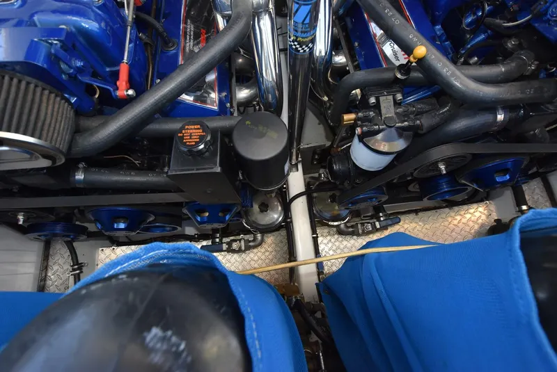 Slide: The Image of Engine compartment of a 2002 Black Thunder 460 EC boat with blue components. - 40