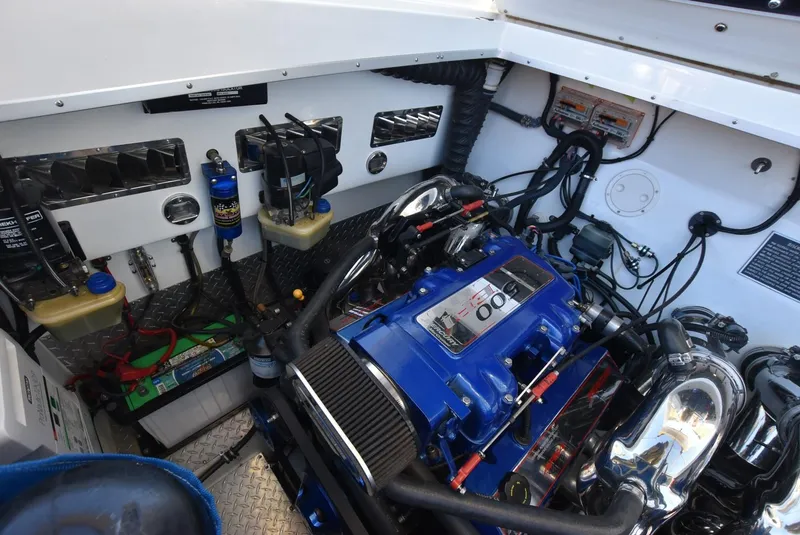 Slide: The Image of Engine compartment of a 2002 Black Thunder 460 EC boat with blue engine components. - 41