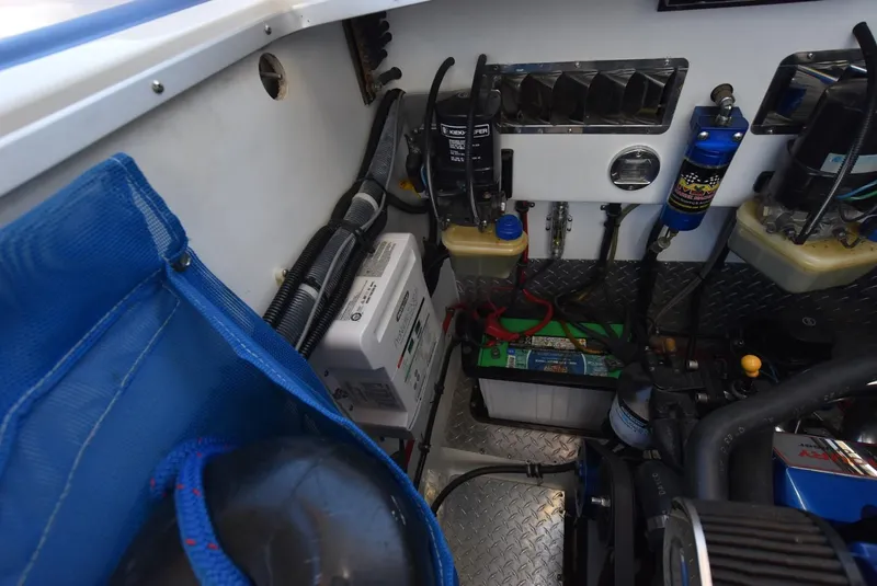 Slide: The Image of Engine compartment of a 2002 Black Thunder 460 EC boat with various components and wiring. - 42