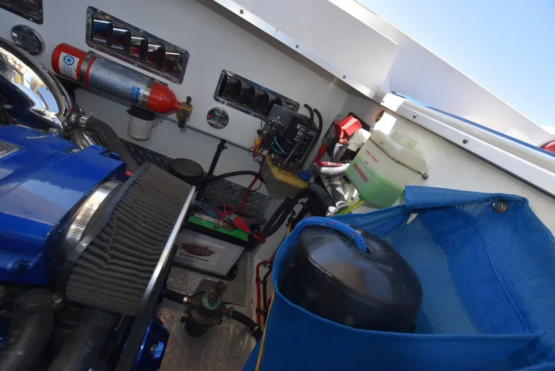 Slide: The Image of Engine compartment of a 2002 Black Thunder 460 EC boat with various components and equipment. - 43