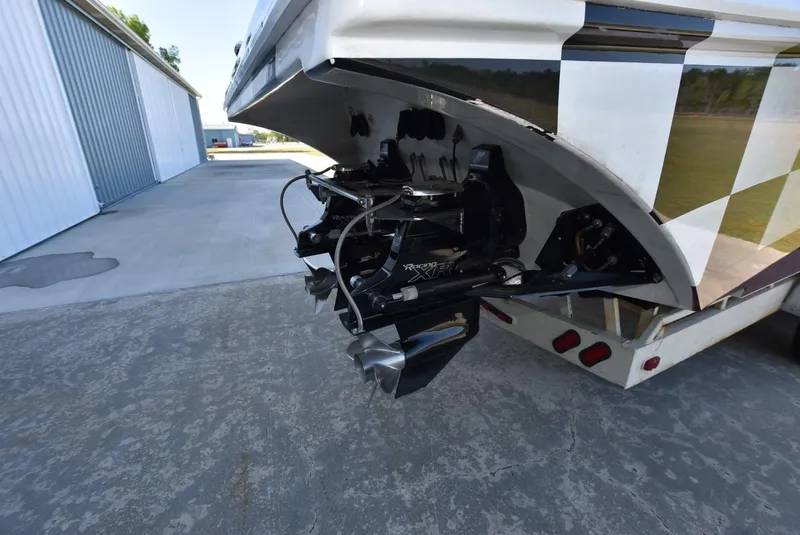 Slide: The Image of 2002 Black Thunder 460 EC boat on trailer, rear view of propellers and stern. - 5