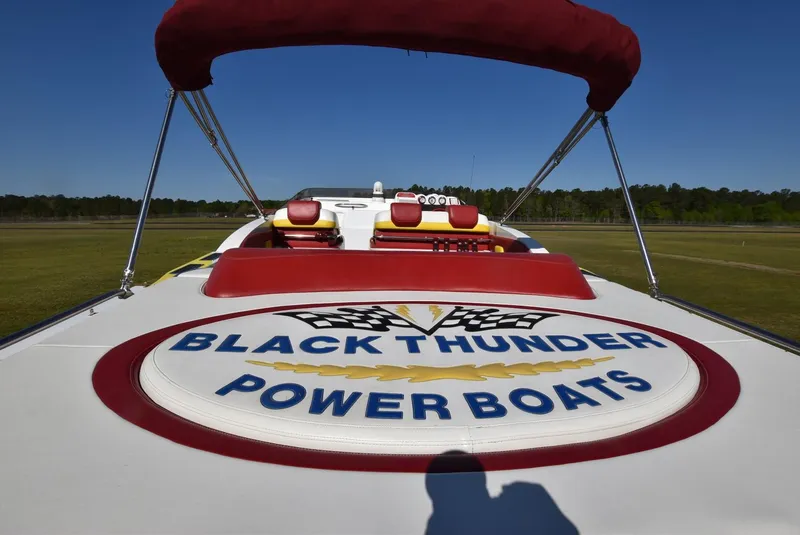 Slide: The Image of 2002 Black Thunder 460 EC power boat with logo and red canopy. - 8