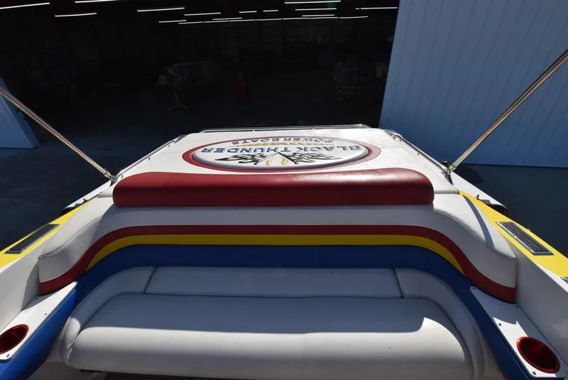 Slide: The Image of 2002 Black Thunder 460 EC boat with colorful seating and logo. - 9