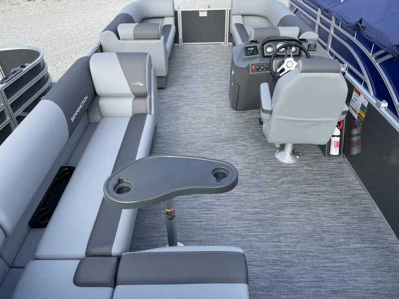 Slide: The Image of 2024 Bennington 20 SVLSR pontoon boat interior with gray seating and captain's chair. - 2