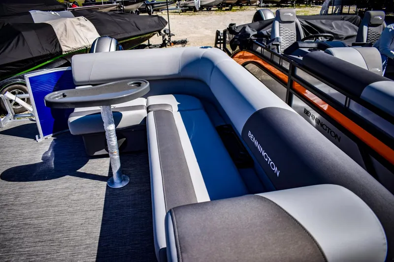 Slide: The Image of 2024 Bennington 20 SVLSR pontoon boat interior with cushioned seating and table. - 10