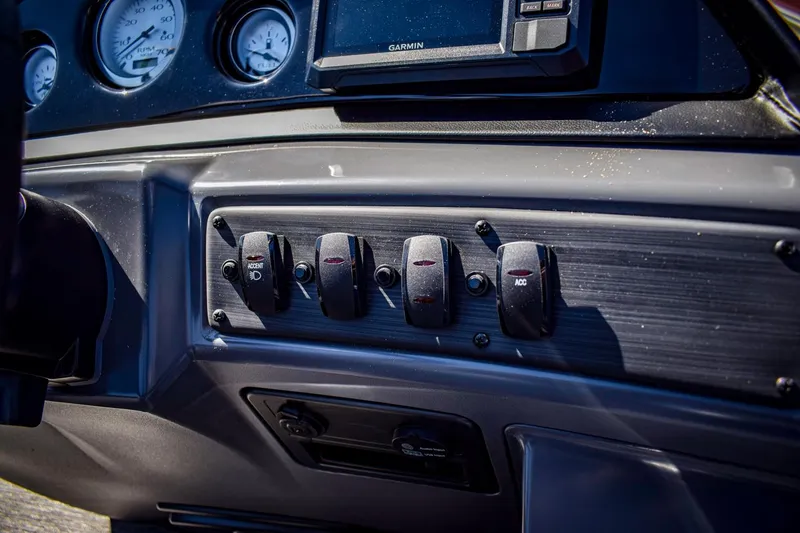 Slide: The Image of 2024 Bennington 20 SVLSR boat dashboard with switches and gauges. - 18