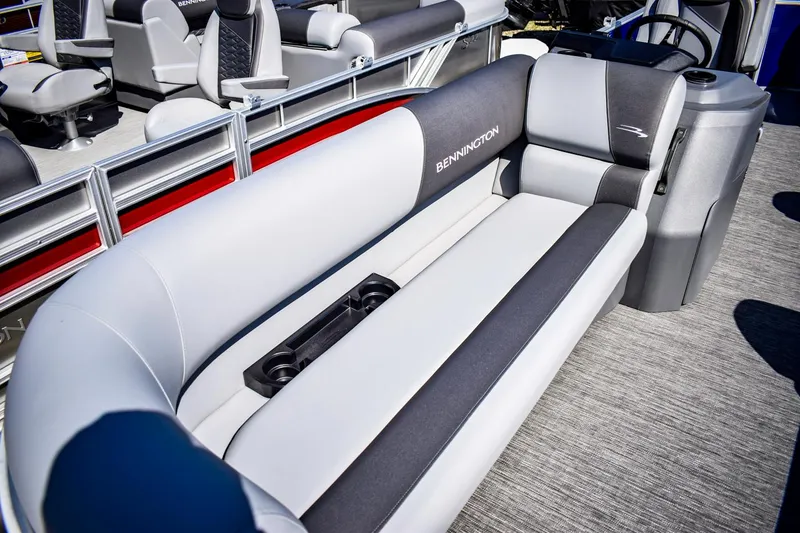 Slide: The Image of 2024 Bennington 20 SVLSR pontoon boat interior with gray seating and cup holders. - 5
