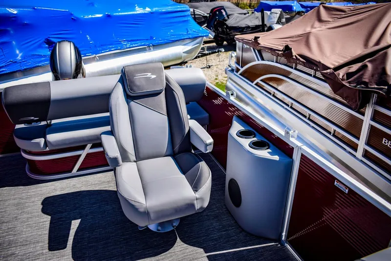 Slide: The Image of 2024 Bennington 20 SVSBSR pontoon boat interior with captain's chair and seating. - 10