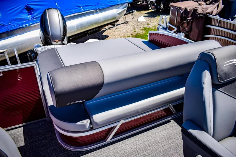Slide: The Image of 2024 Bennington 20 SVSBSR pontoon boat interior with gray seating and red accents. - 18