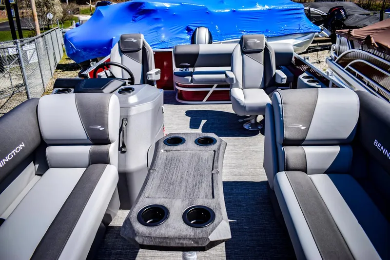 Slide: The Image of 2024 Bennington 20 SVSBSR pontoon boat interior with gray seating and table. - 4