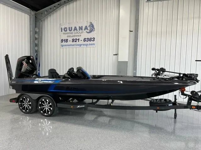 The Image of 2024 iKon LX20 boat on trailer in showroom, Iguana Marine Group sign in background. - 1
