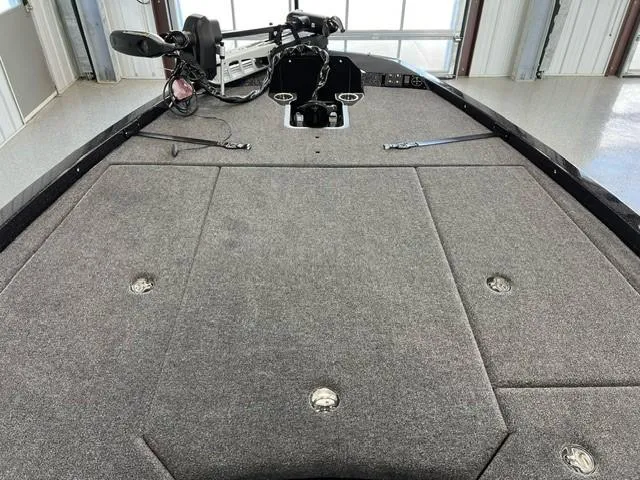 Slide: The Image of 2024 iKon LX20 boat interior with carpeted deck and fishing equipment. - 10