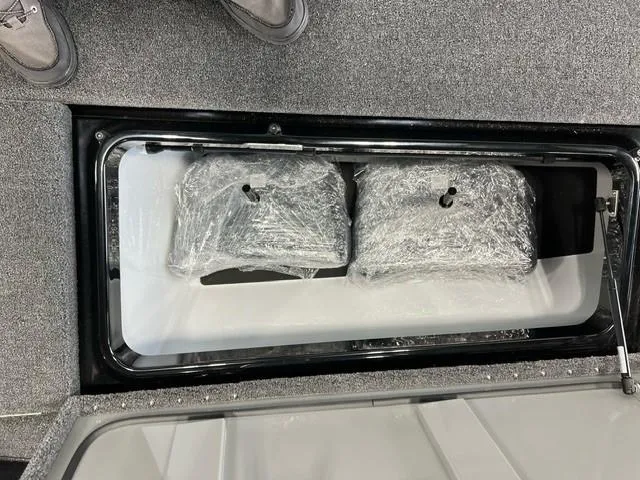 Slide: The Image of Storage compartment of 2024 iKon LX20 boat with wrapped items inside. - 12
