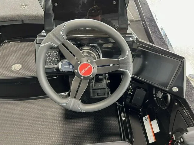 Slide: The Image of 2024 iKon LX20 boat steering wheel and dashboard with modern controls and display. - 15