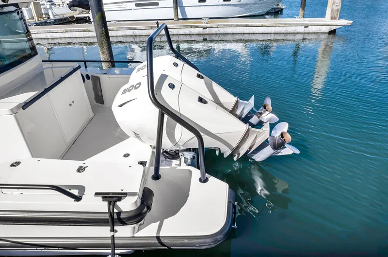 Slide: The Image of 2022 Axopar 28 CABIN boat with dual outboard engines docked in marina. - 17
