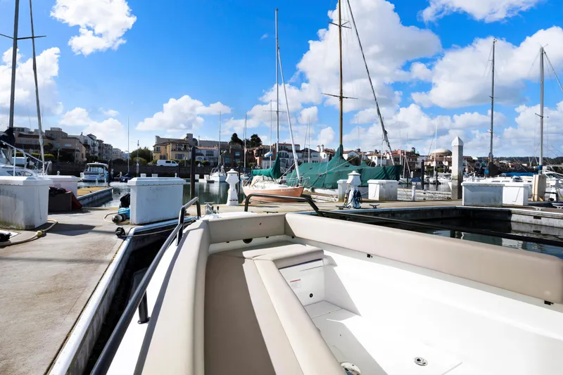 Slide: The Image of Axopar 28 CABIN 2022 boat docked at a marina with clear blue skies. - 19